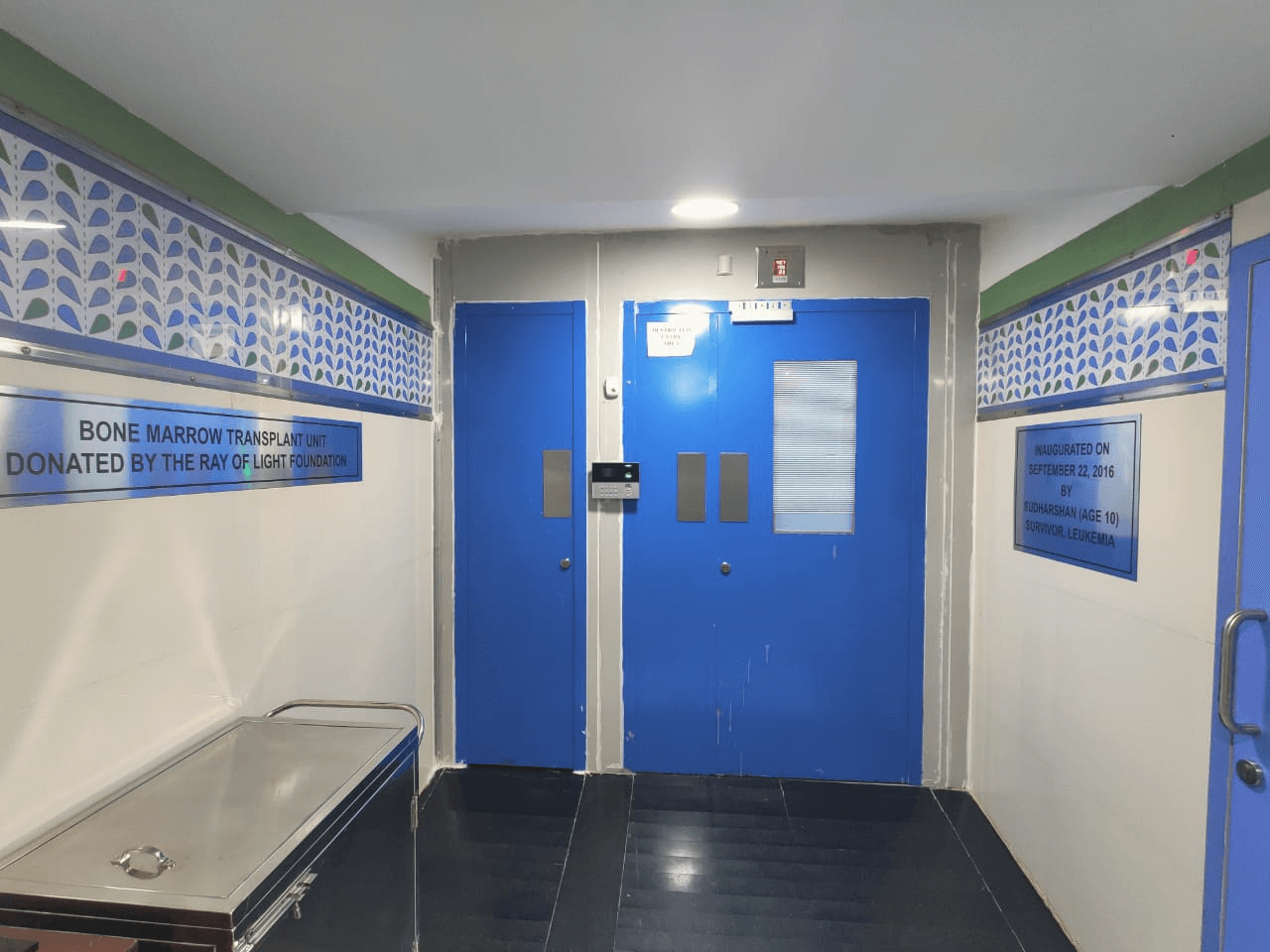Bone Marrow Transplant Unit entrance with blue doors and descriptive plaques.