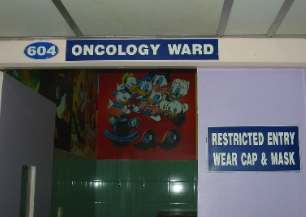 Entrance to 604 Oncology Ward with cartoon mural and restricted entry sign.