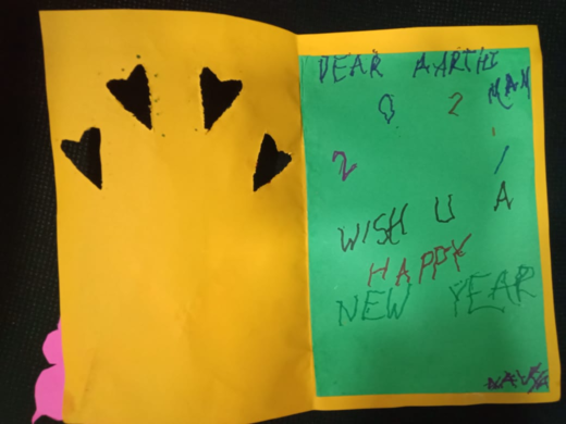 Happy New Year' card to Dr. Arathi with black heart cutouts.